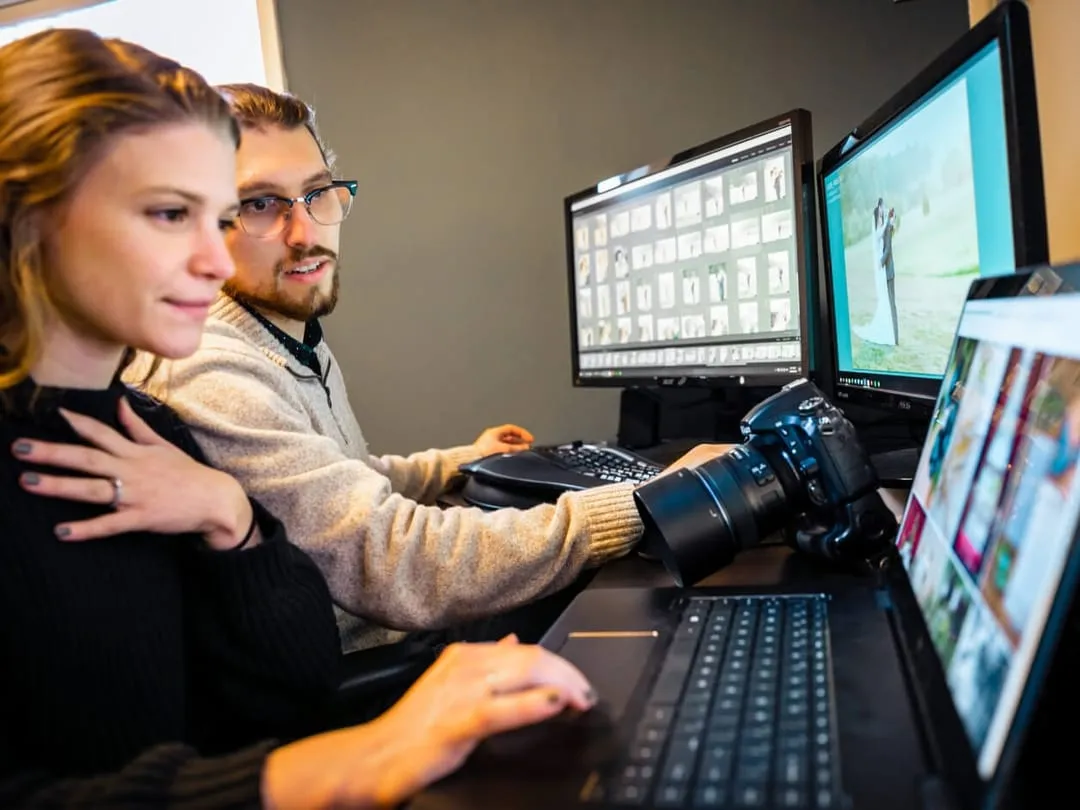 Two content creators behind numerous screens and devices connected to the internet.