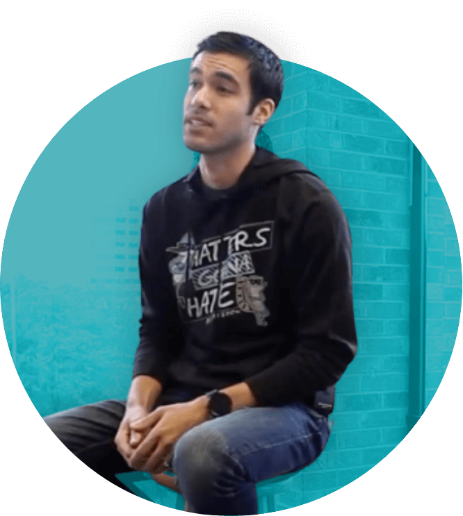 Man in black hoodie sitting, blue background