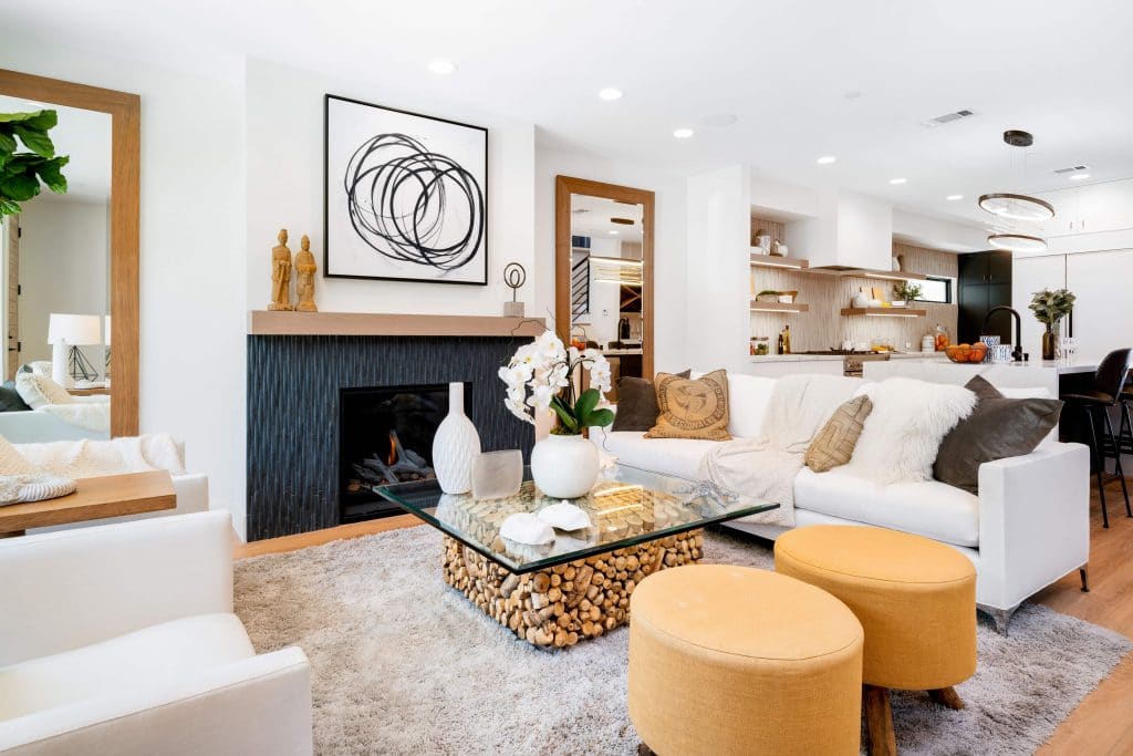 Modern and luxurious beach house living room with fireplace and glass top table