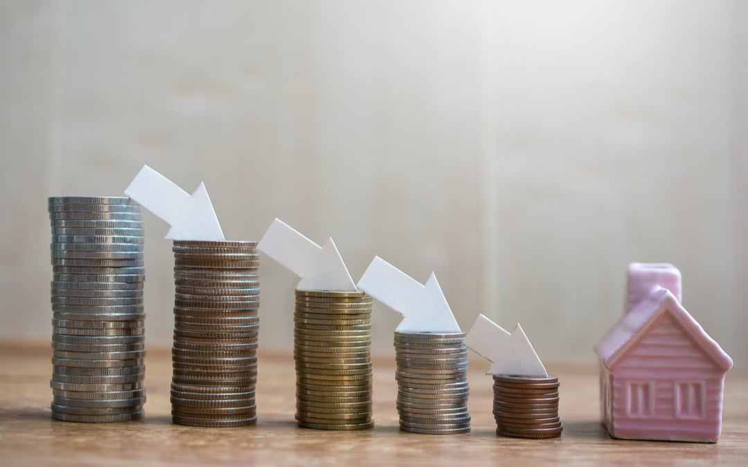 Stacks of coins and downward arrows