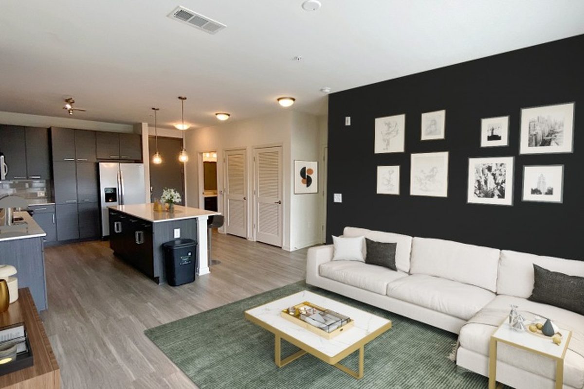 The living room and open kitchen in an apartment home at Ayla on Krog