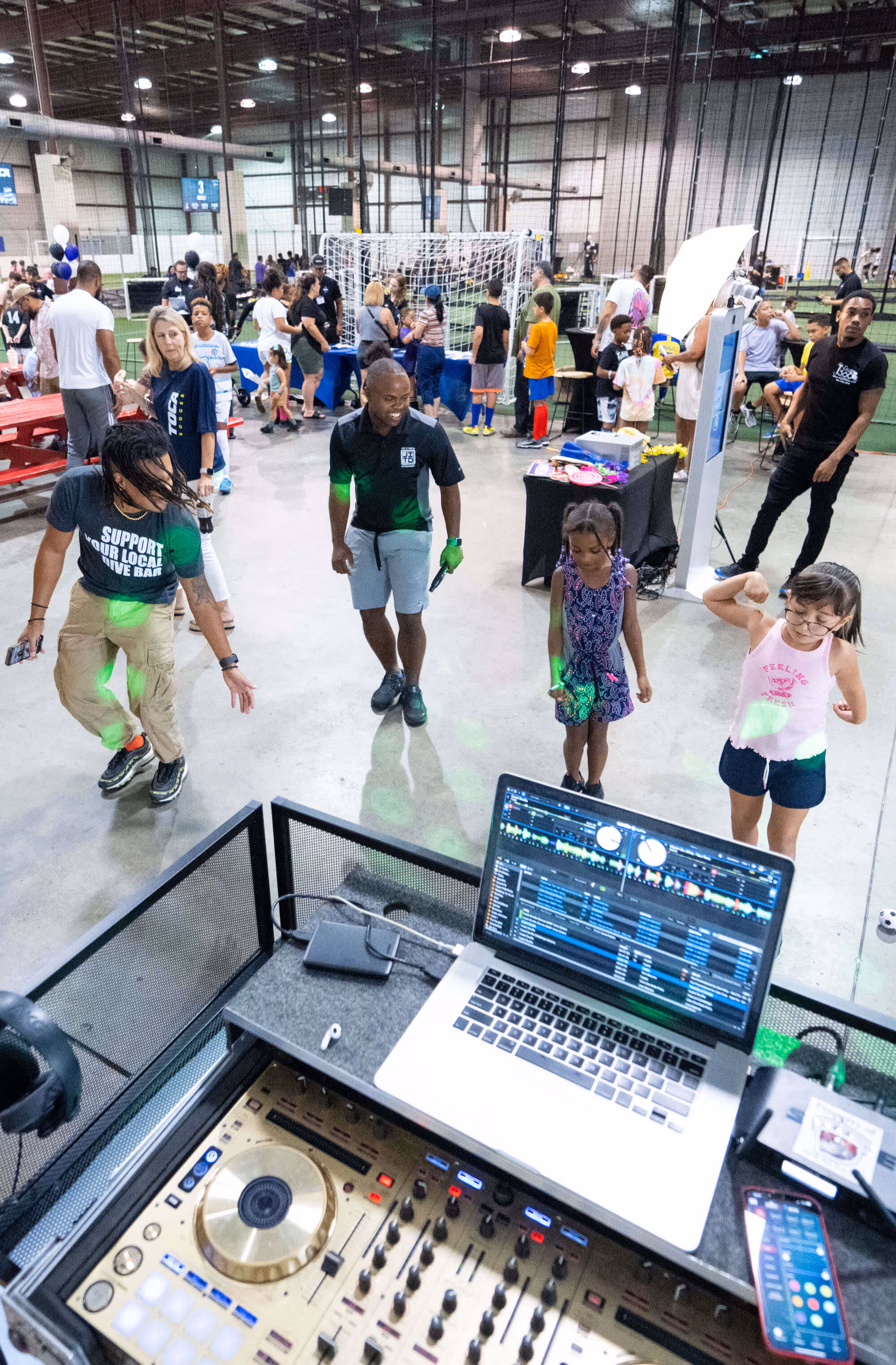 Kids and adults dancing at a TOCA community event