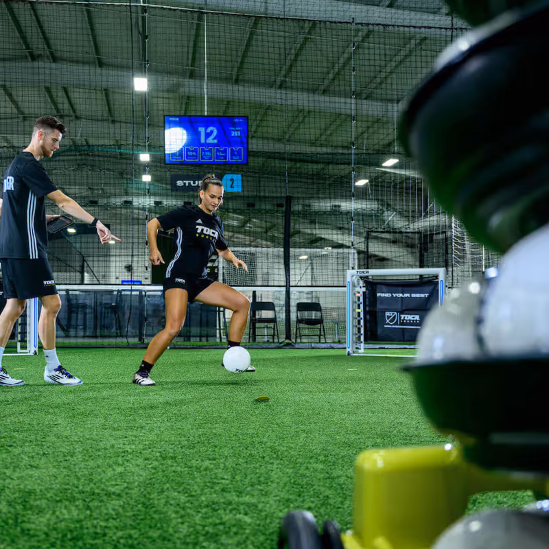 TOCA Soccer coach training a soccer player with TOCA Touch Trainer ball delivery System.