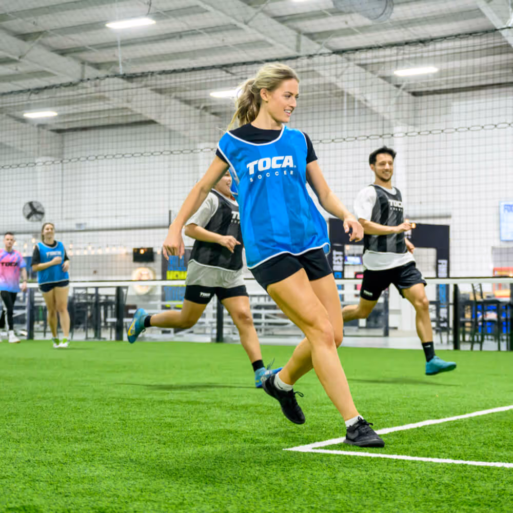 Pickup soccer player competing on a TOCA indoor soccer field. 