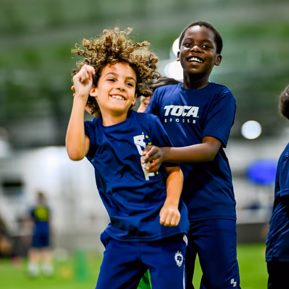 Young soccer player kicking ball
