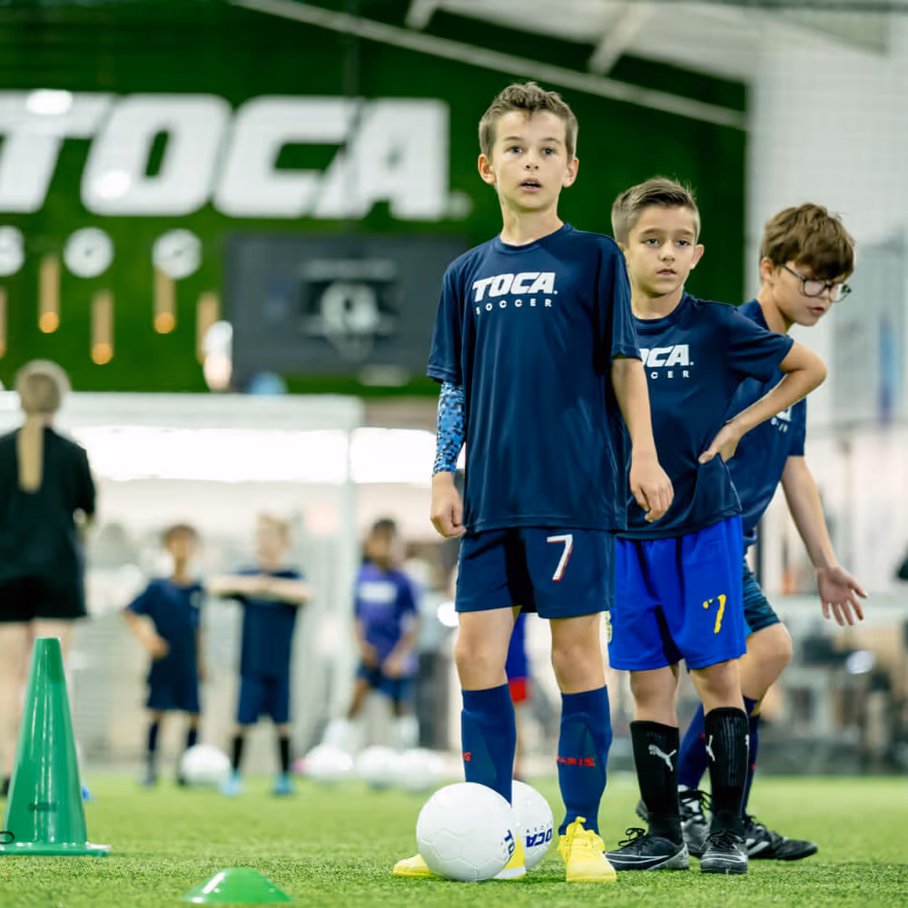 Kid soccer players lined up for drill practice