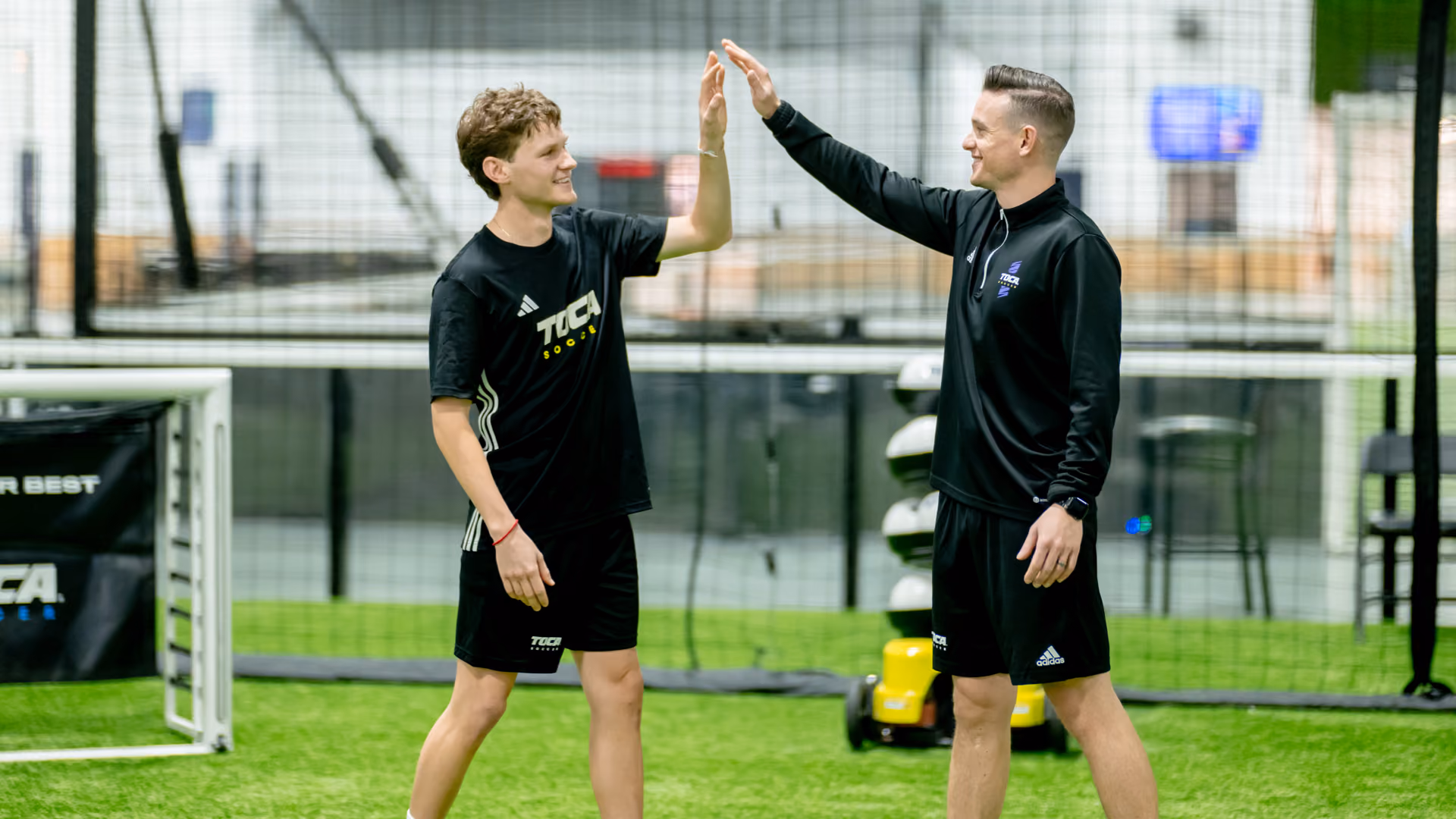 TOCA trainer high-fiving a teen player after private training session