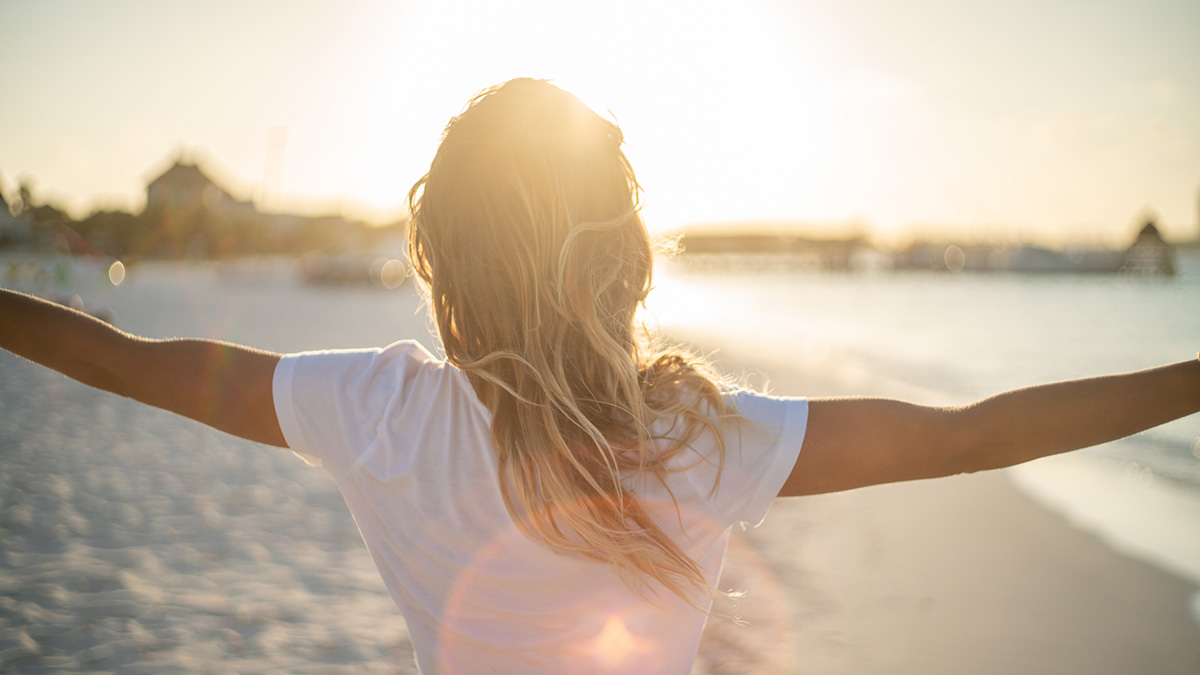 A person feeling good on a beach.