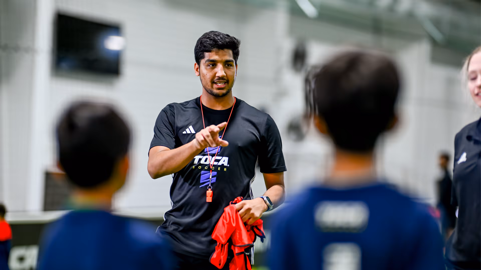 TOCA coach supporting young soccer players with encouragement and guidance before their big game day.