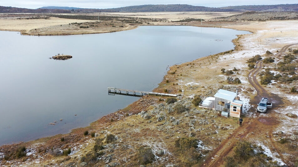 Remote lakeside cabin with jetty at a trout fishing lake in Tasmania’s