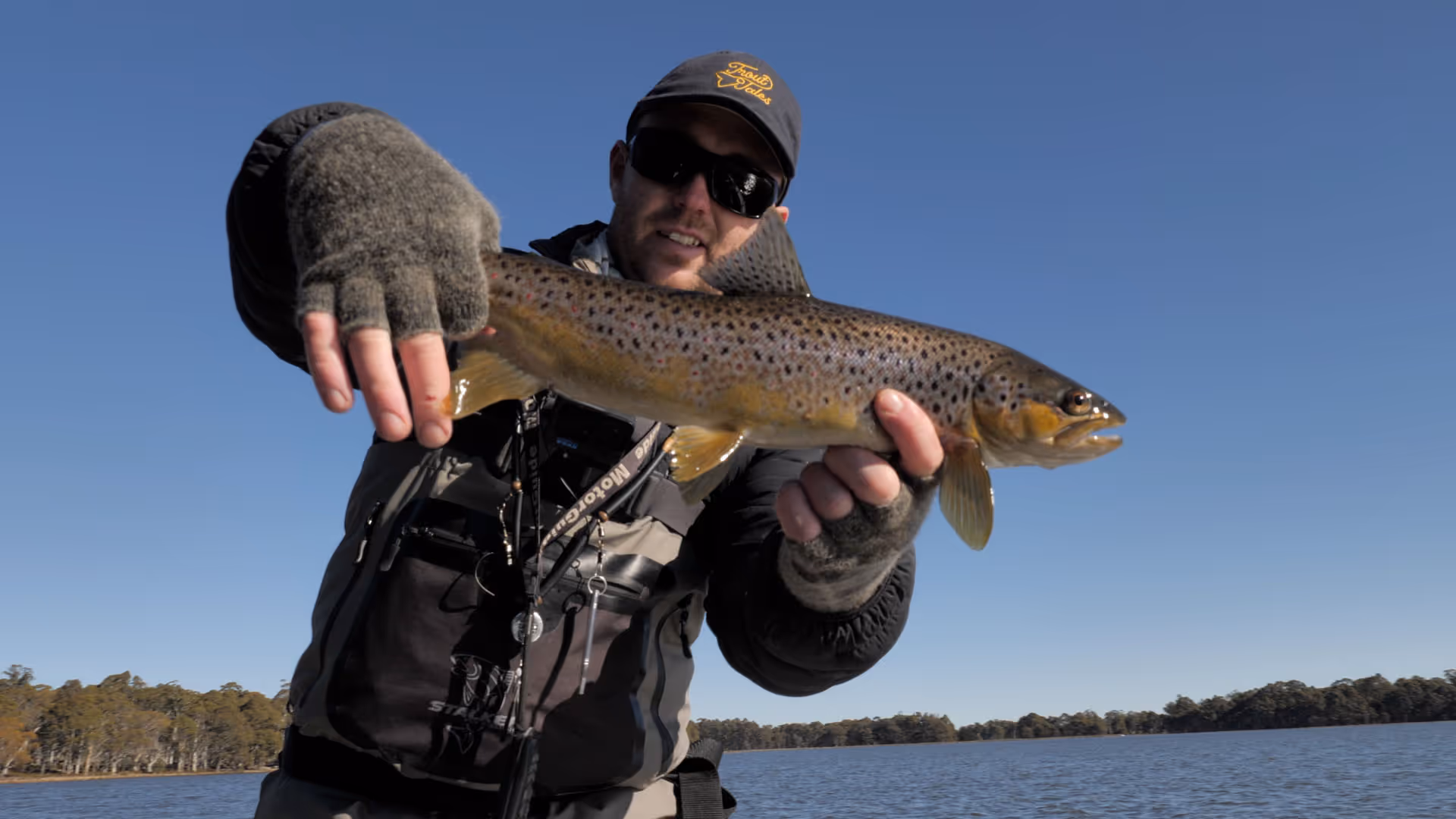 matt holding brown tasmanian trout up to camera