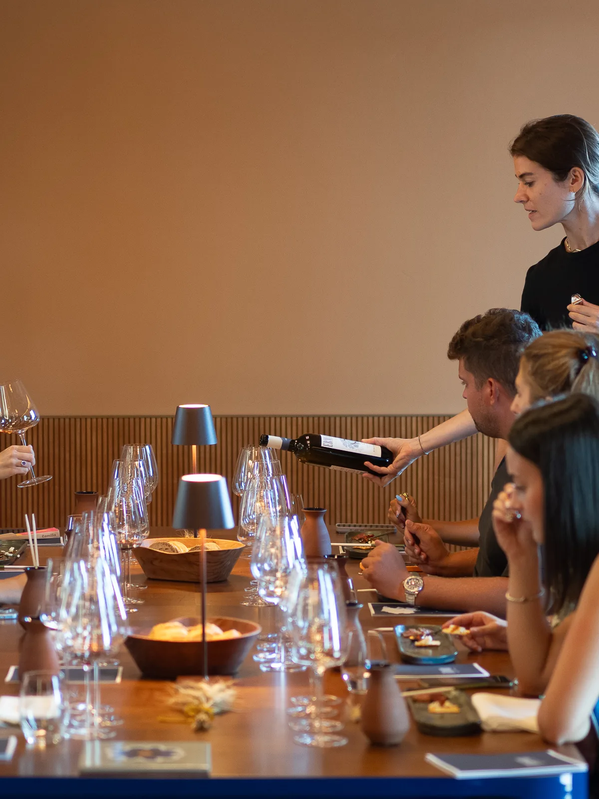 Group wine tasting in the Ermacora winery’s tasting room, with wine served at the table