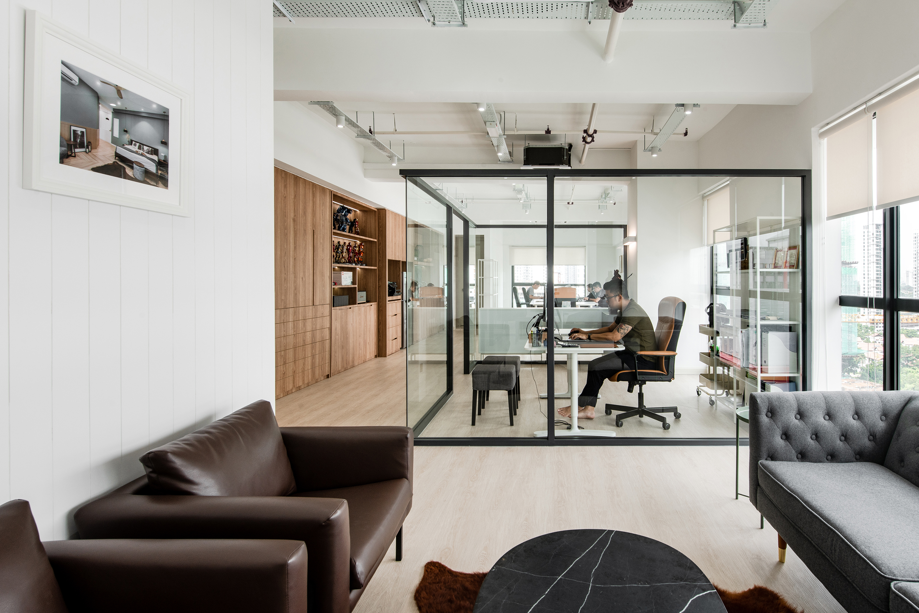 Open office layout with glass room in the middle. PSQ Office
