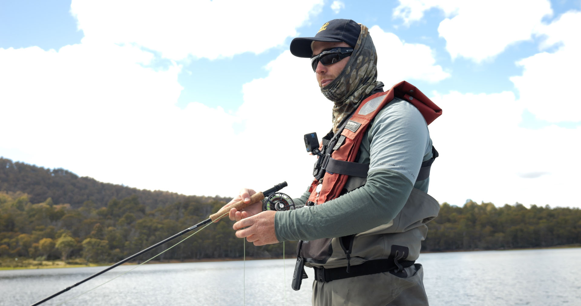 matt standing on boat with rod and reel in hand