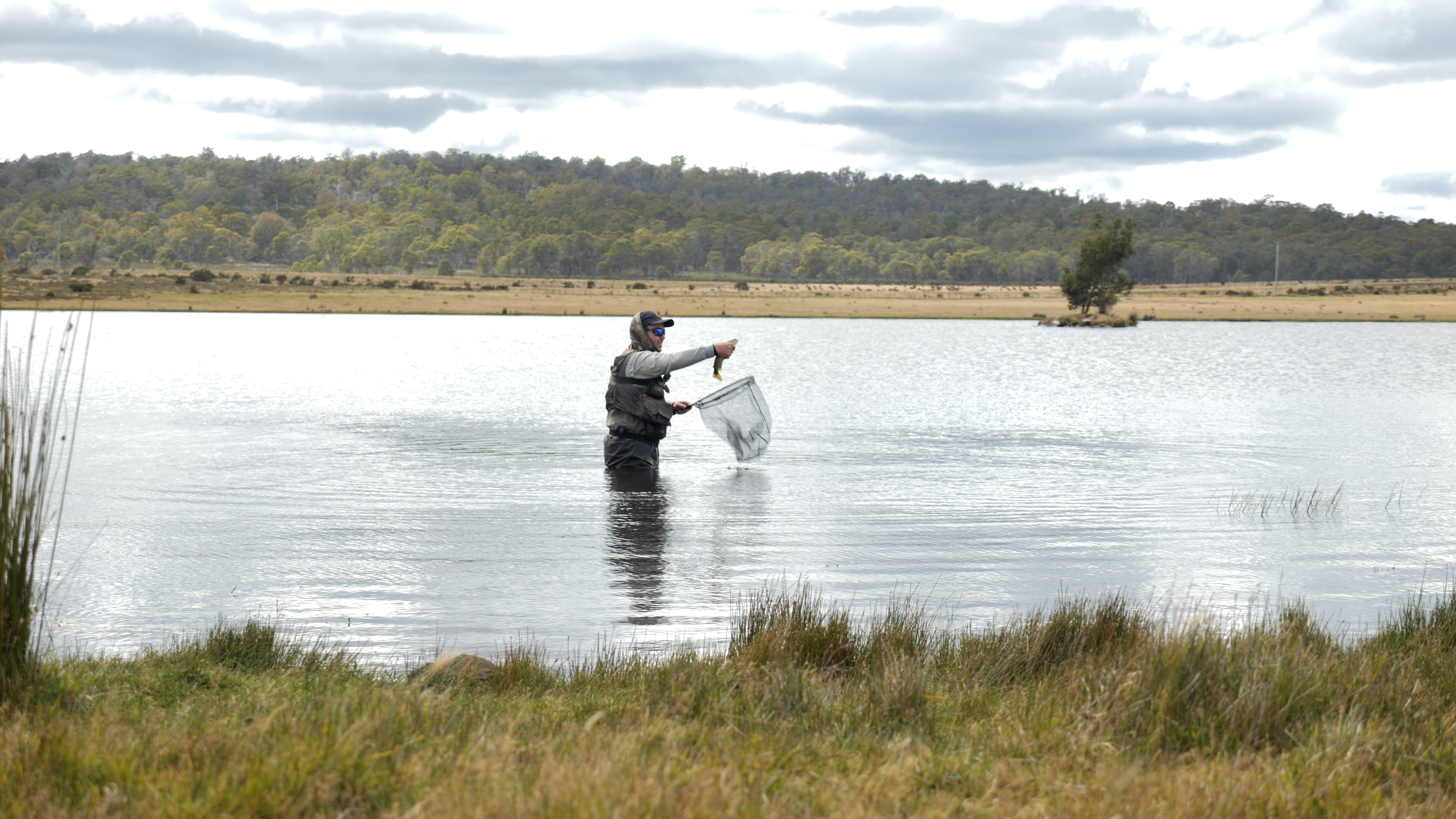 matt in water holding up a fish