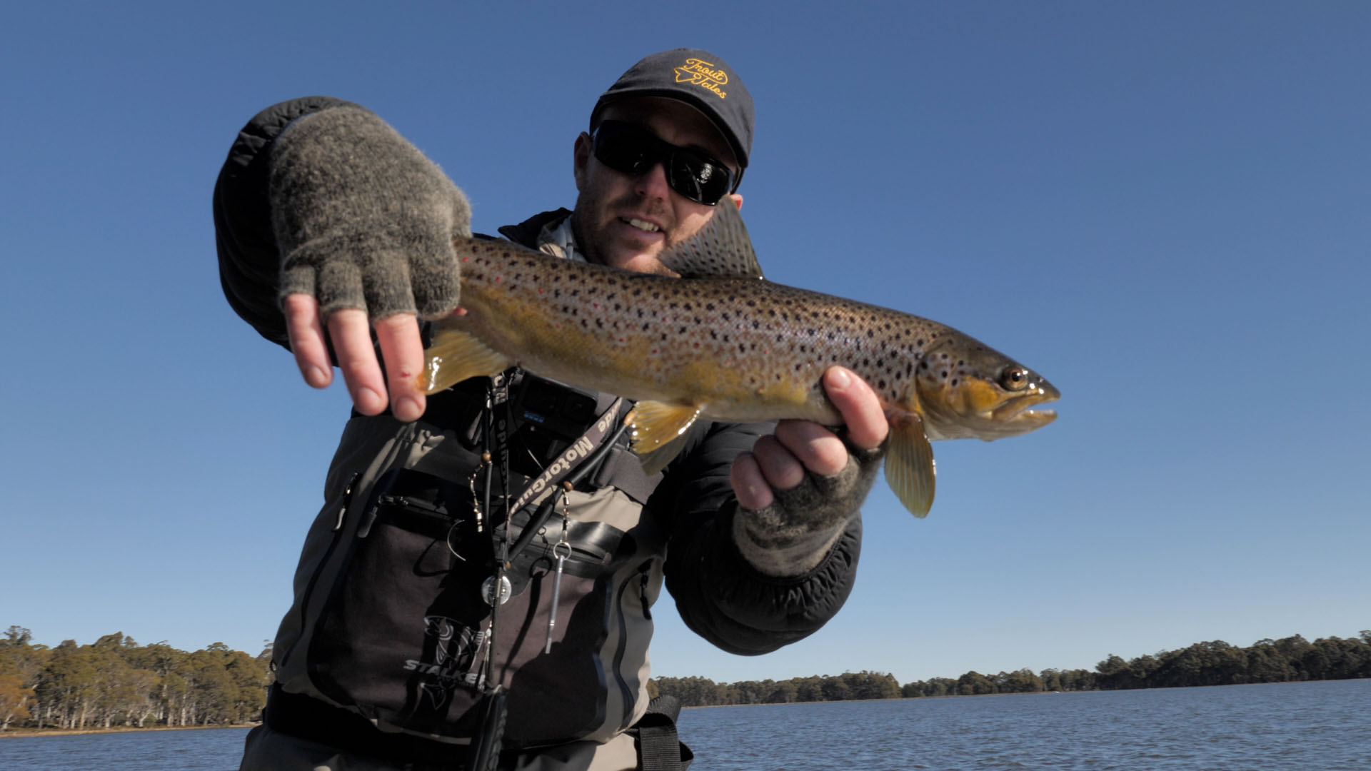 matt in trout tales hat holding brown trout
