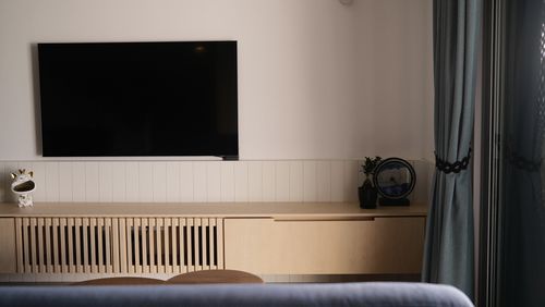 A cozy living room with a wall-mounted TV.