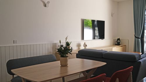 Cozy living room with table, chairs, and TV
