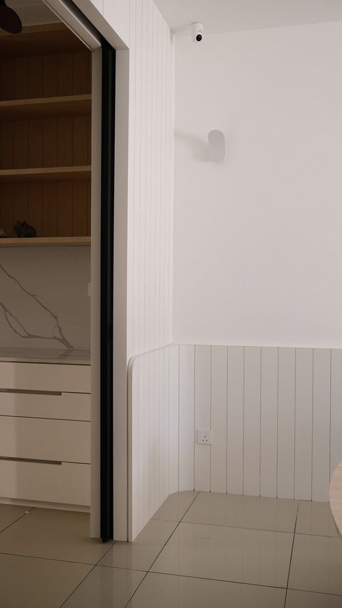 White kitchen with cabinet and table.