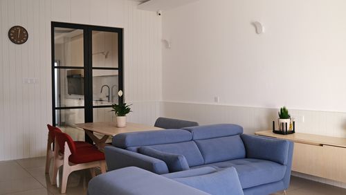 A cozy dining area featuring a blue couch and a table.
