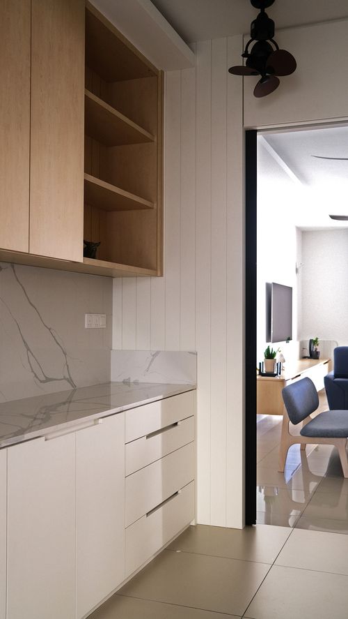 A white kitchen base with stone countertop and backsplash