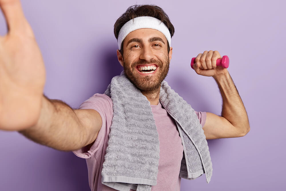 man posing on a purple background