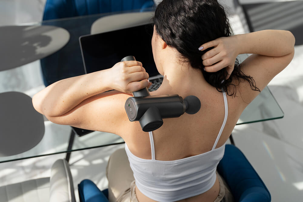 woman with a back massager
