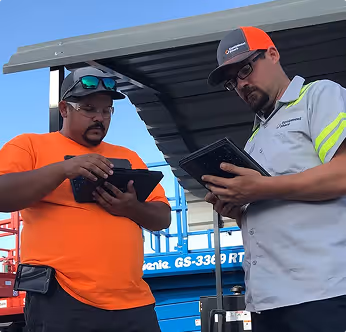Two EquipmentShare employees looking at tablets