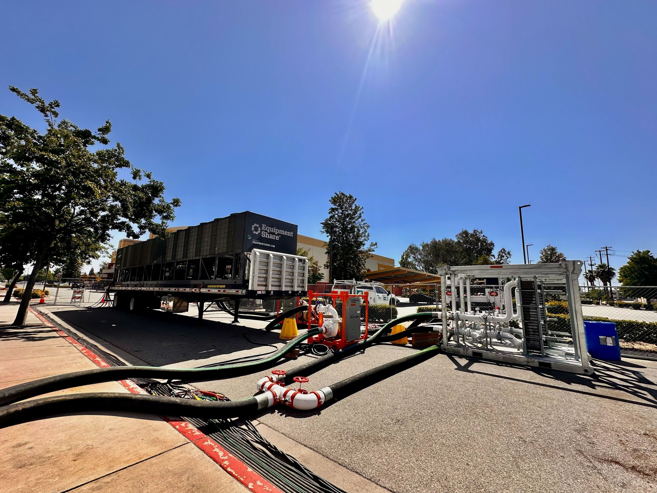 Trailer-mounted chillers and portable cooling units connected onsite with distribution hoses