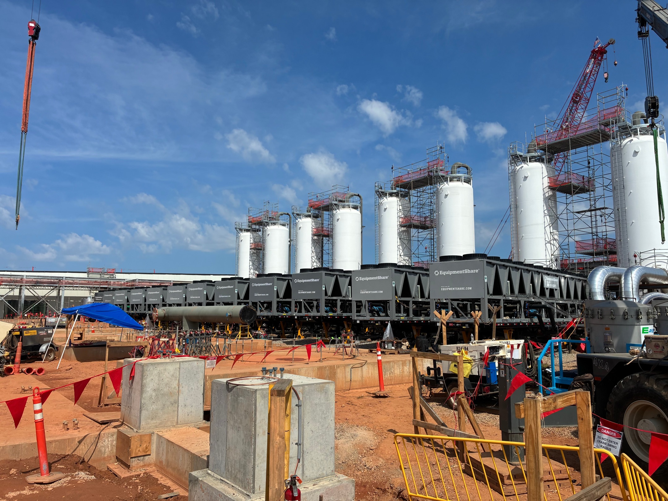 Storage silos under construction with temporary power distribution onsite