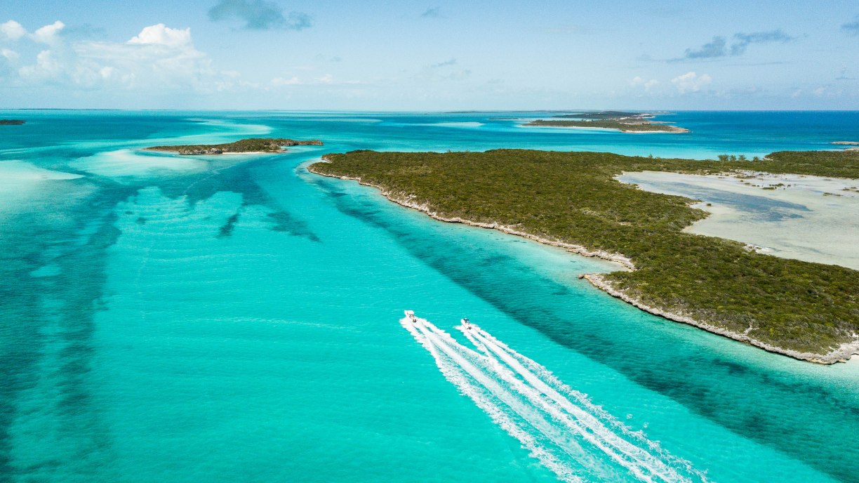 seating area on a boat with blue and orange patterned pillows