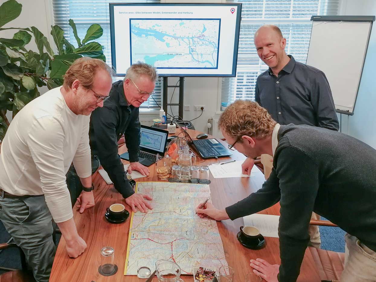 Picture of Flying Fish and Elbtaxi team members analyzing water mobility solutions for Hamburg