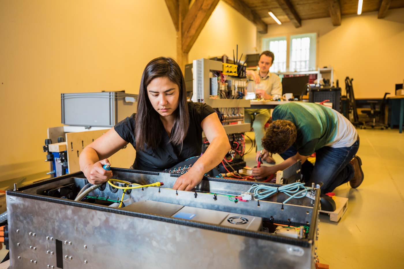 Picture of Flying Fish team members working on the SWIM hydrogen-electric propulsion system for the watertaxi in Rotterdam