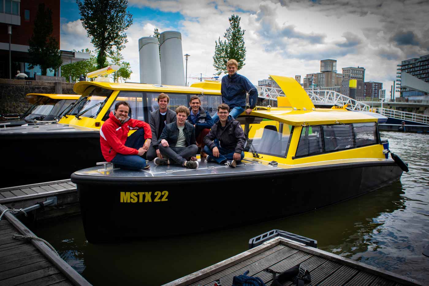 Picture of team members with the Flying Fish SWIM hydrogen-electric watertaxi in Rotterdam