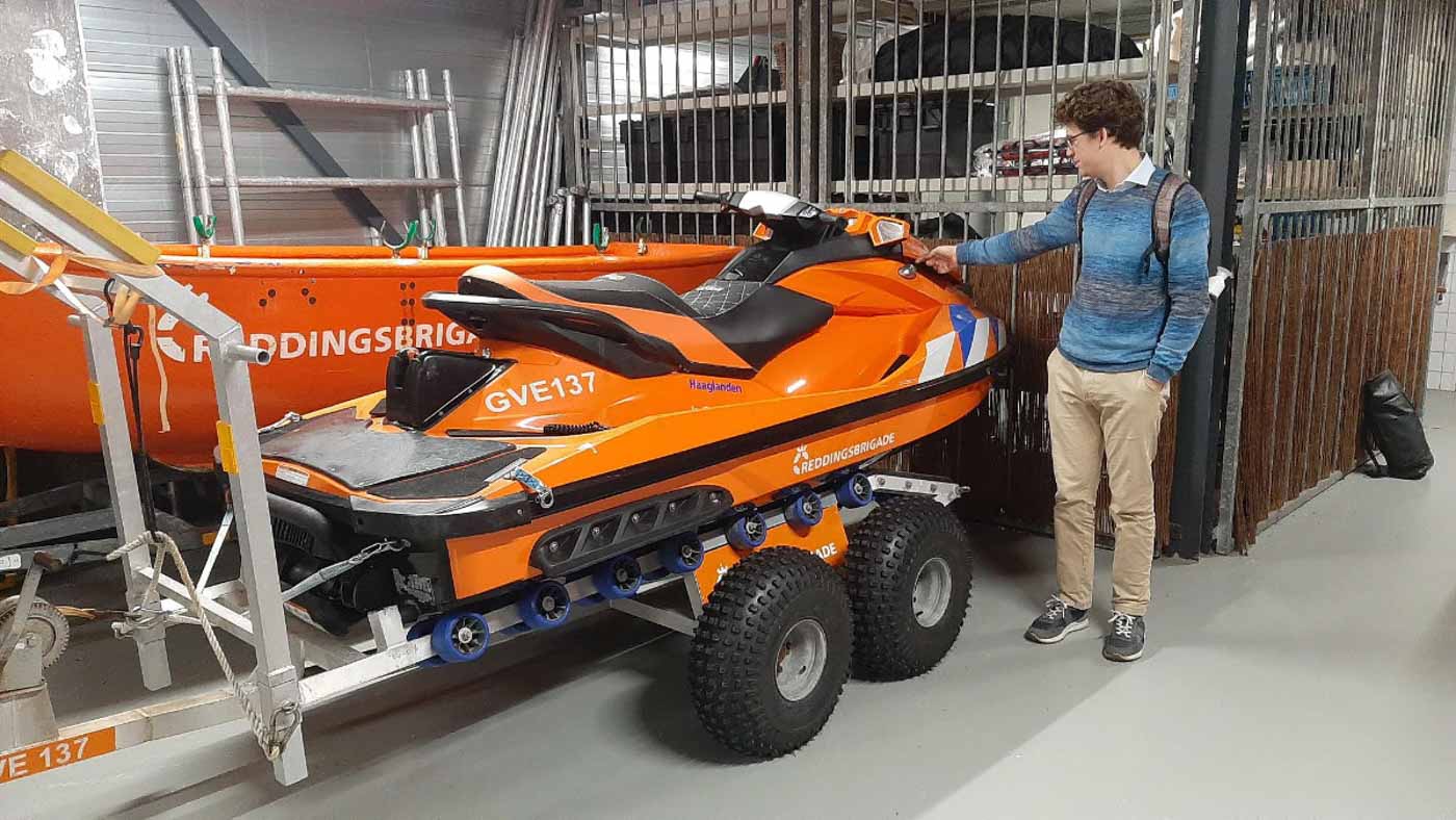 Picture of Flying Fish team member with a Dutch Lifeguards (Reddingsbrigade) watercraft on a trailer