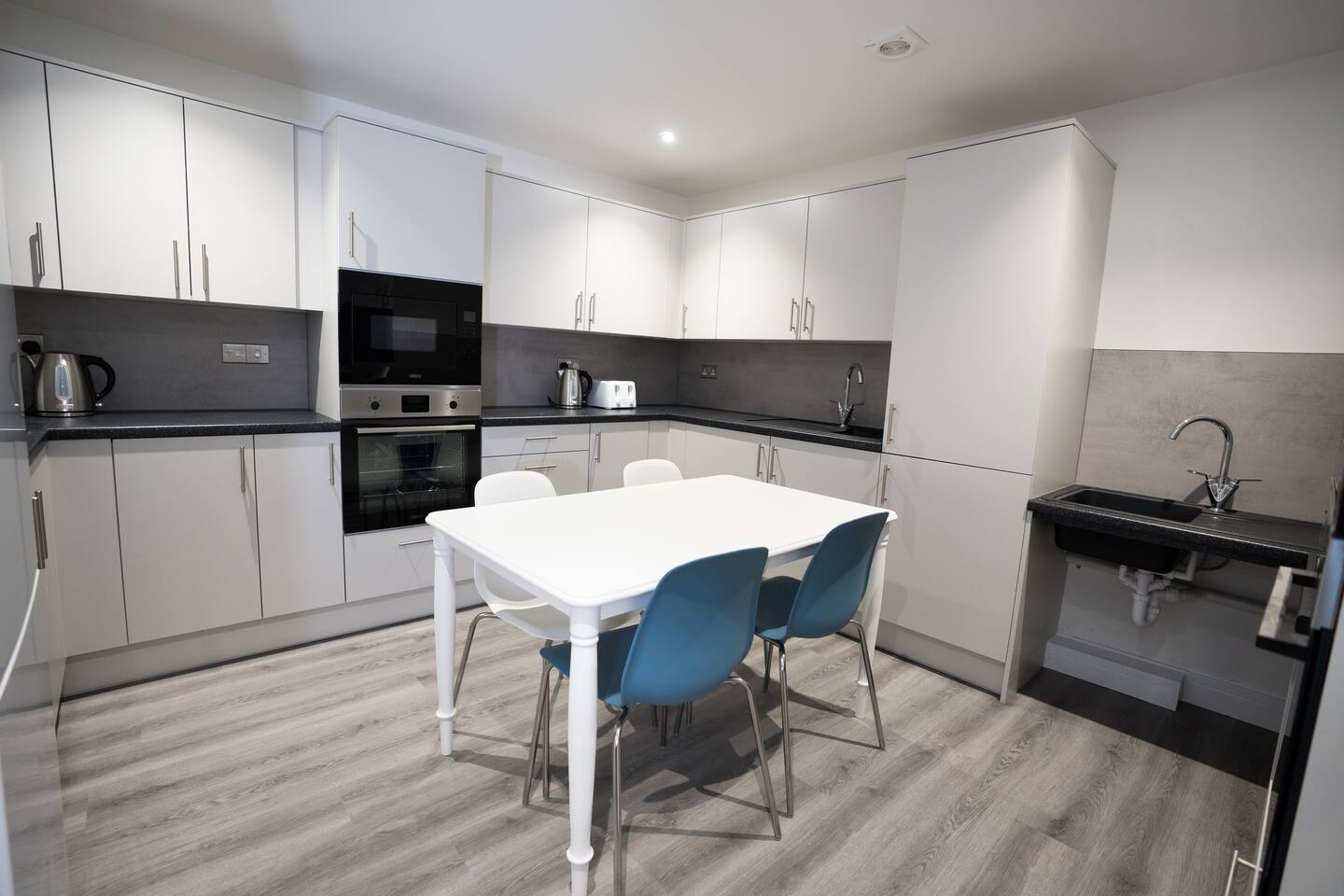 Fully equipped shared kitchen and dining area at Ryegate House