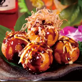 Chopped octopus stuffing, rolled into balls and fried, toped with shaved, dried fish