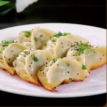 Pan-fried dumplings with a sweet and spicy dipping sauce