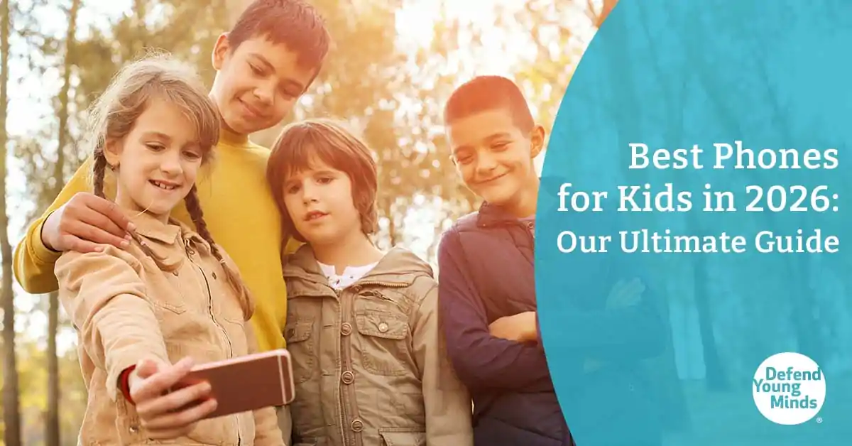 A group of children outside looking at a phone screen.