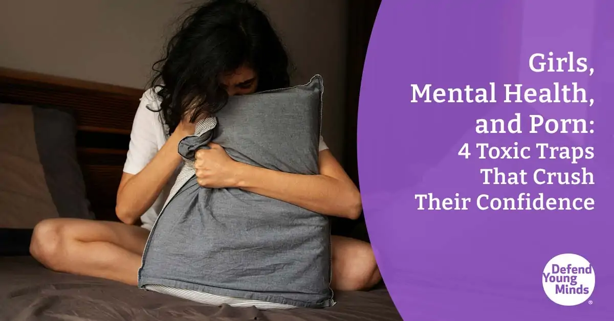 Image of a girl looking sad with her head in a pillow.