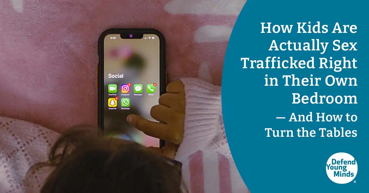 Image of a child on a cell phone in their bedroom.