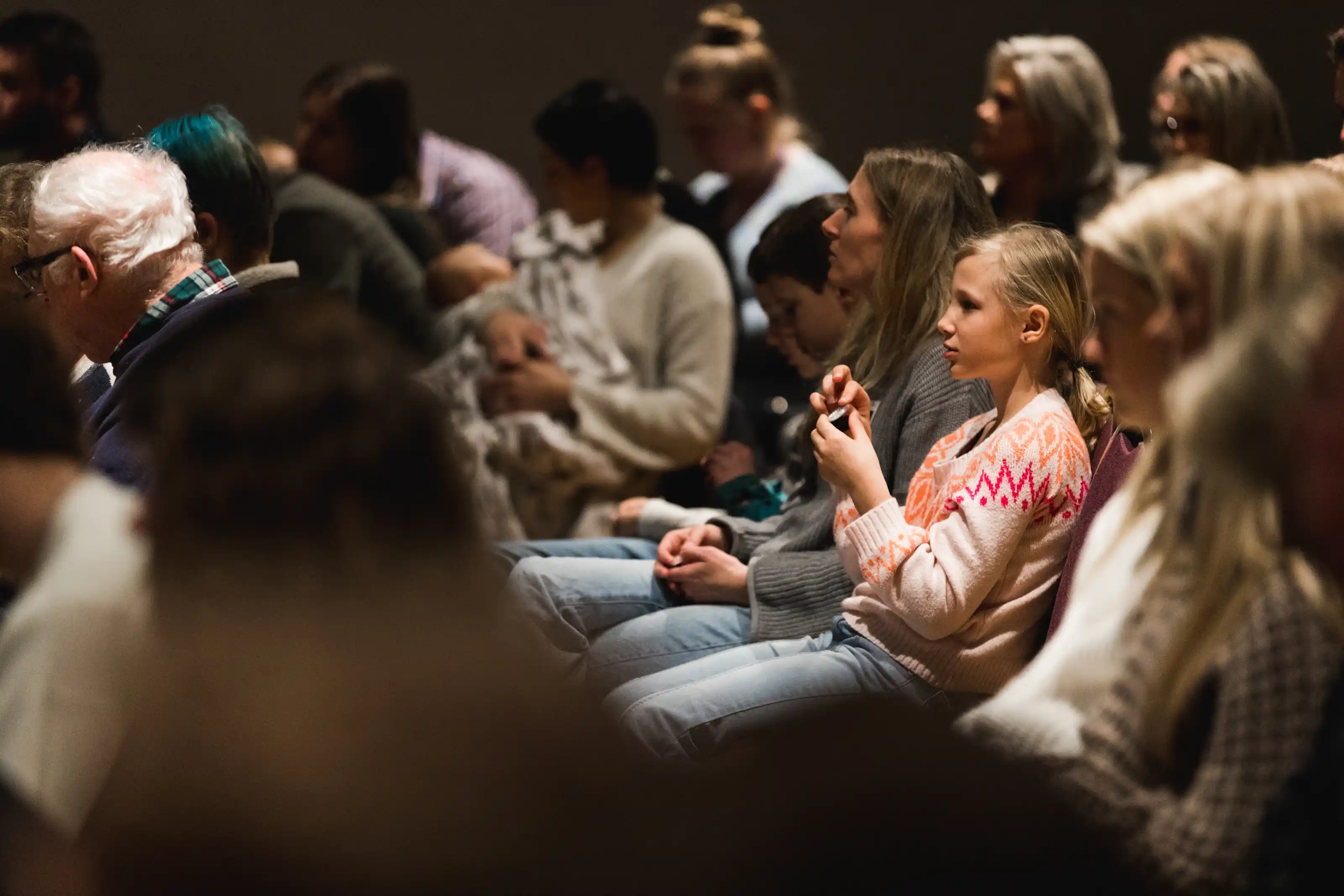 A young girl (kid) listening intently to a Bible message.