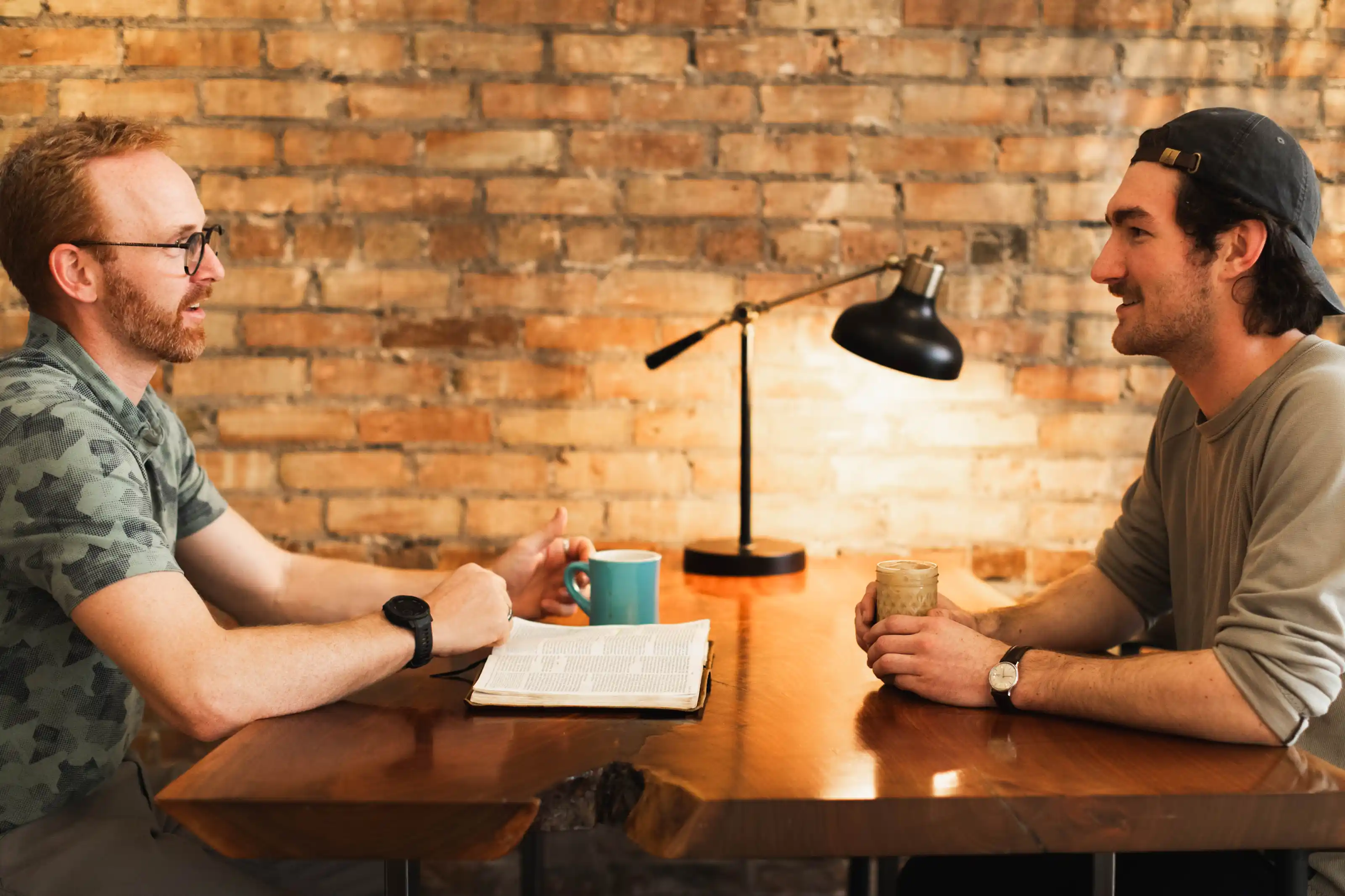 A worship band—bass, piano, guitarist, vocalist—singing on stage in an auditorium