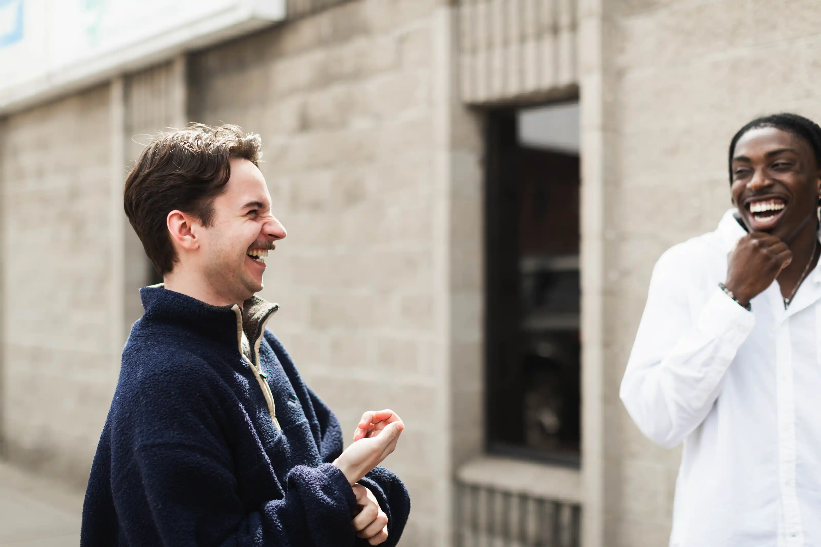 A worship band—bass, piano, guitarist, vocalist—singing on stage in an auditorium