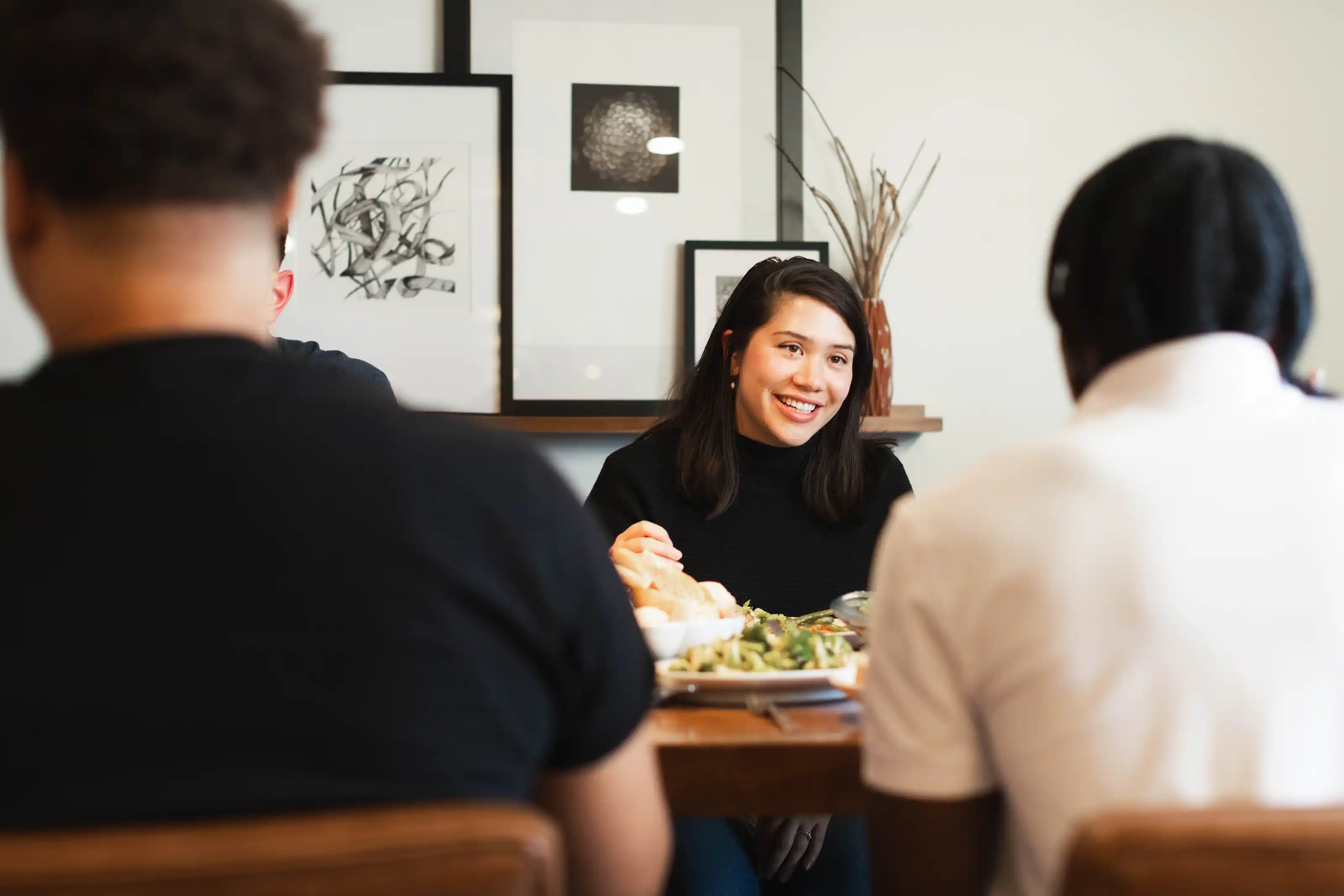 A worship band—bass, piano, guitarist, vocalist—singing on stage in an auditorium