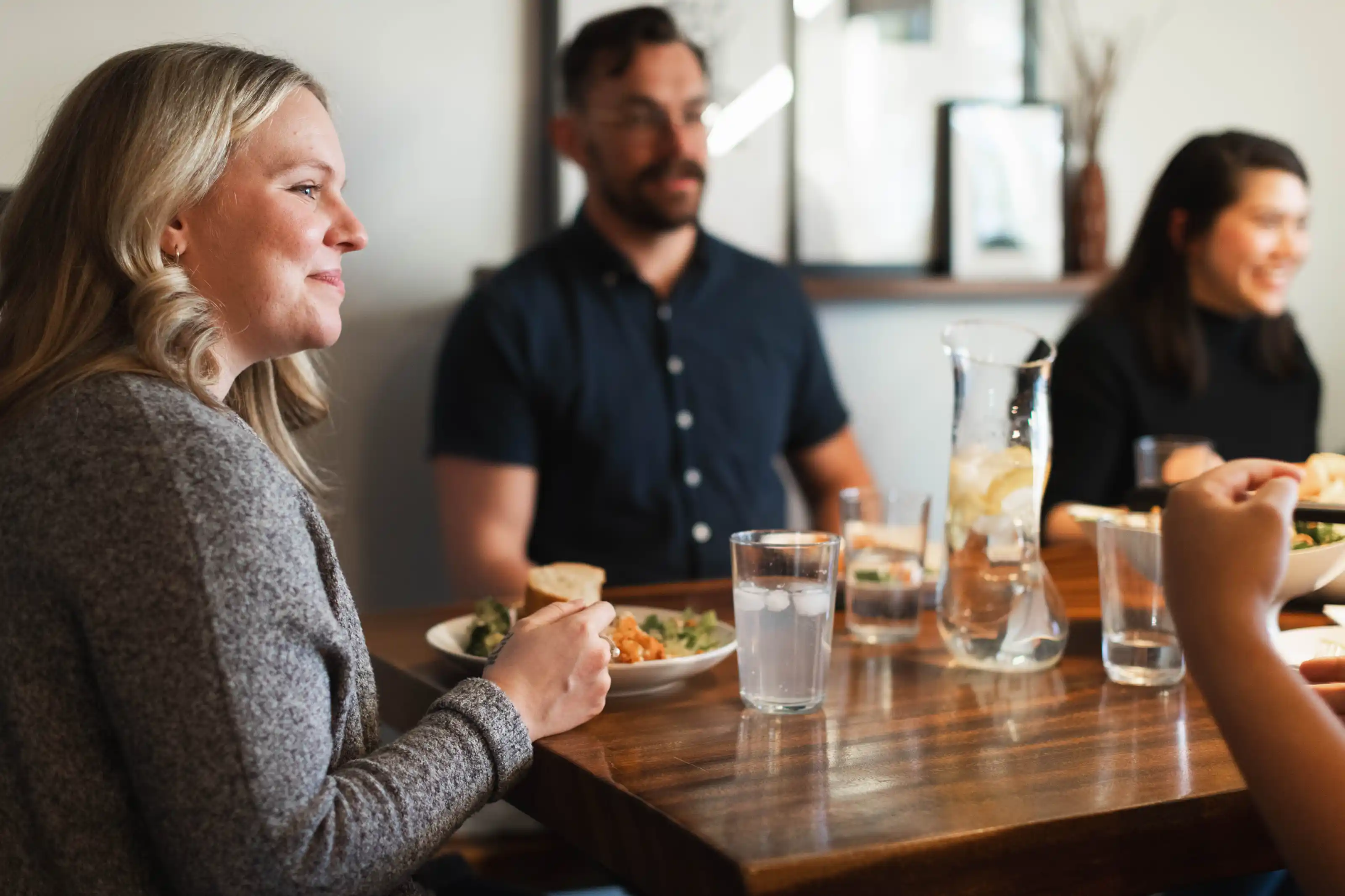A worship band—bass, piano, guitarist, vocalist—singing on stage in an auditorium