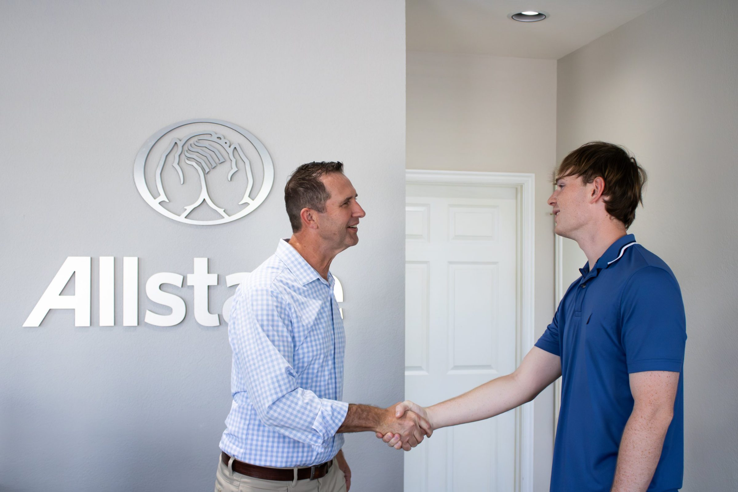 Josh Nelson welcoming a customer with a handshake at his Norman, OK office