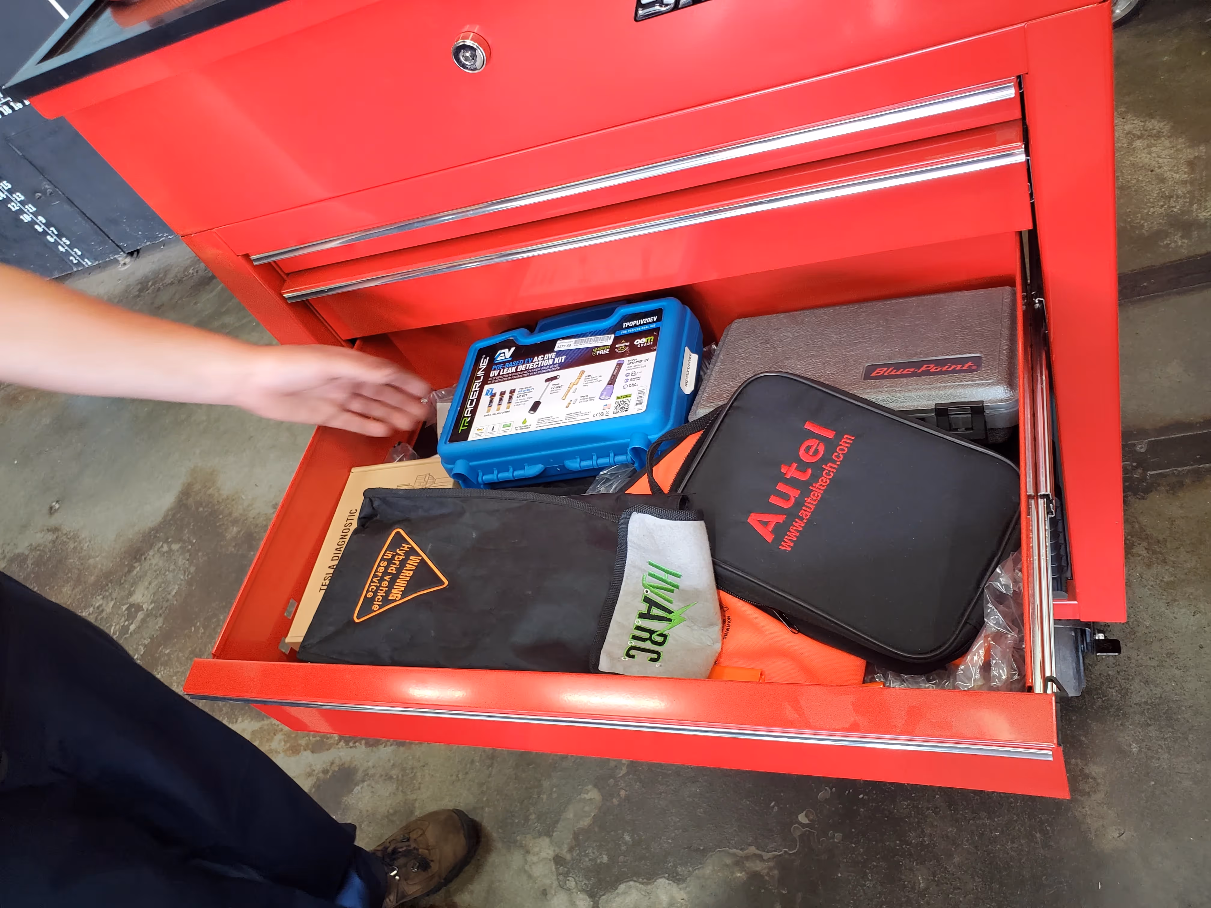 A specialized EV mechanic has certifications and tools to check high voltage batteries