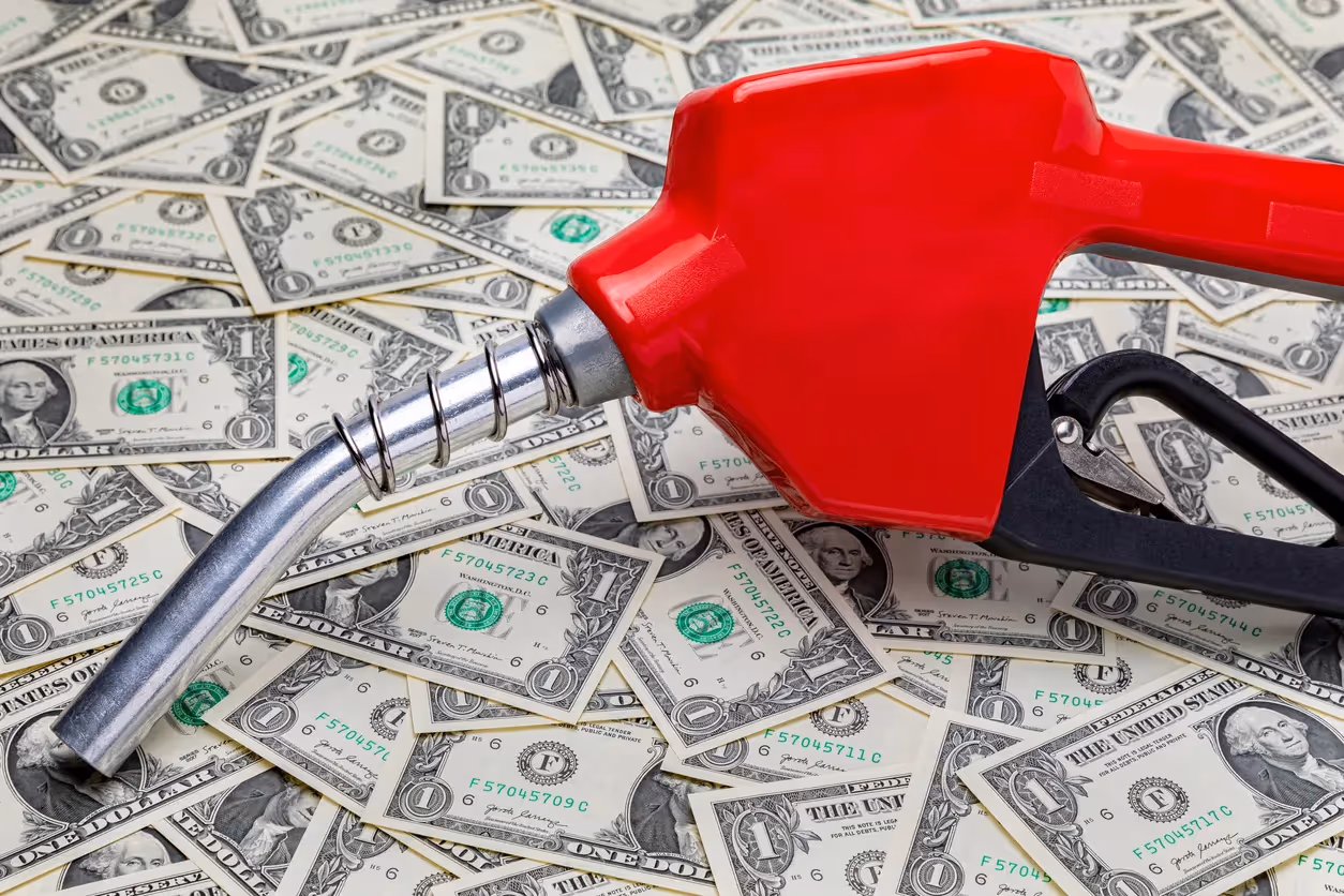 Gas nozzle on top of dollar bills
