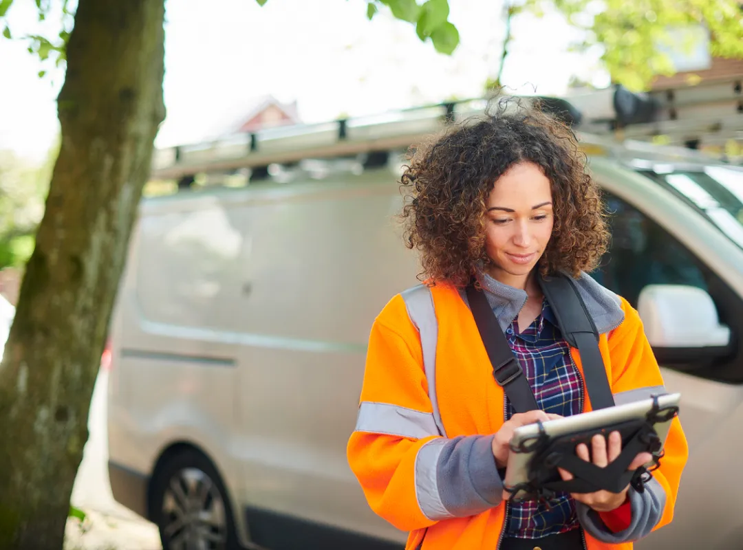 A lady using a tablet whilst at work